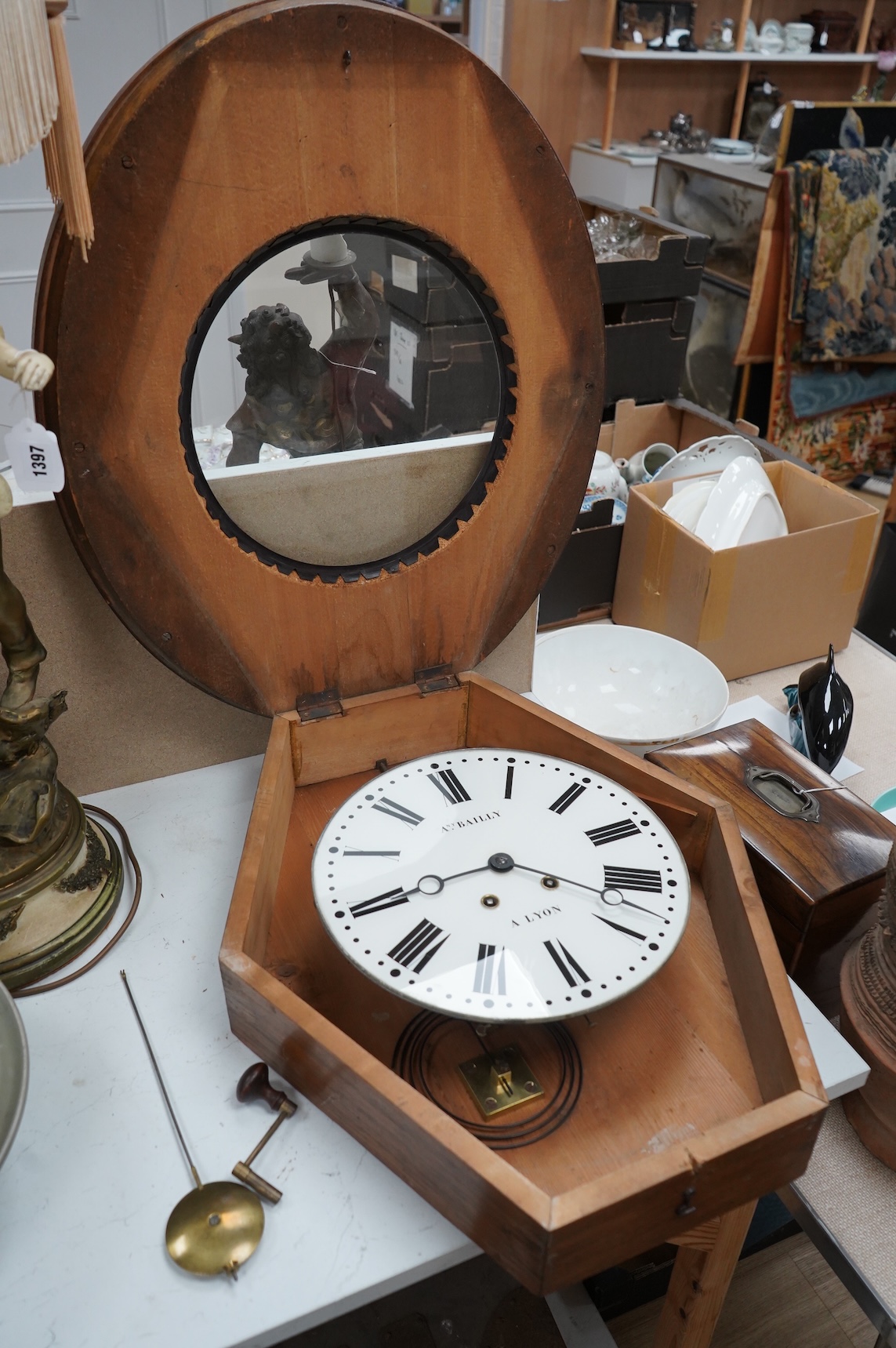 A French oak oval wall clock, the dial inscribed Any. Bailly A Lyon, with pendulum and key, 68cm high